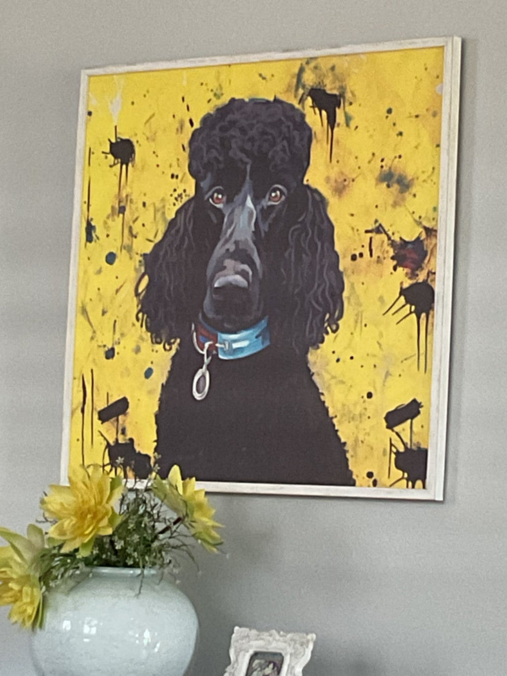 Framed dog portrait displayed above home decor